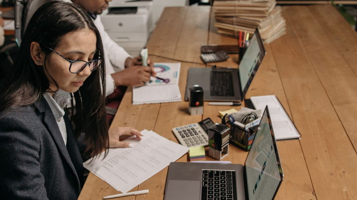 Accounting professionals working with financial documents and business software