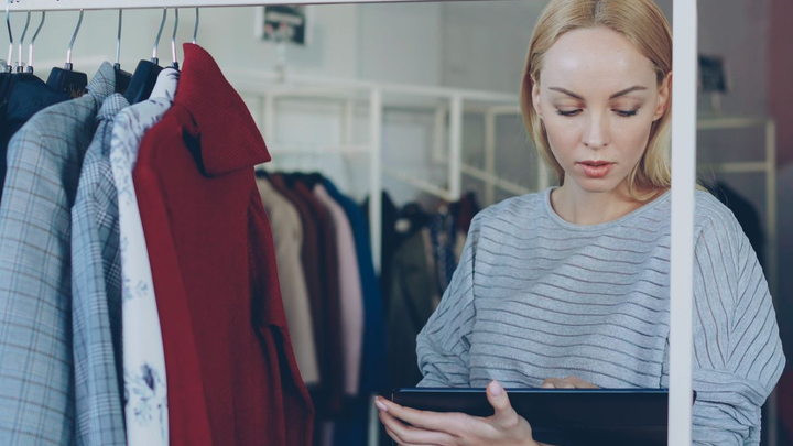 A retail employee using a tablet to manage store operations